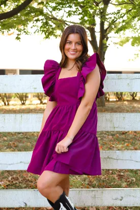 FLUTTER SLEEVE BABYDOLL DRESS IN PLUM