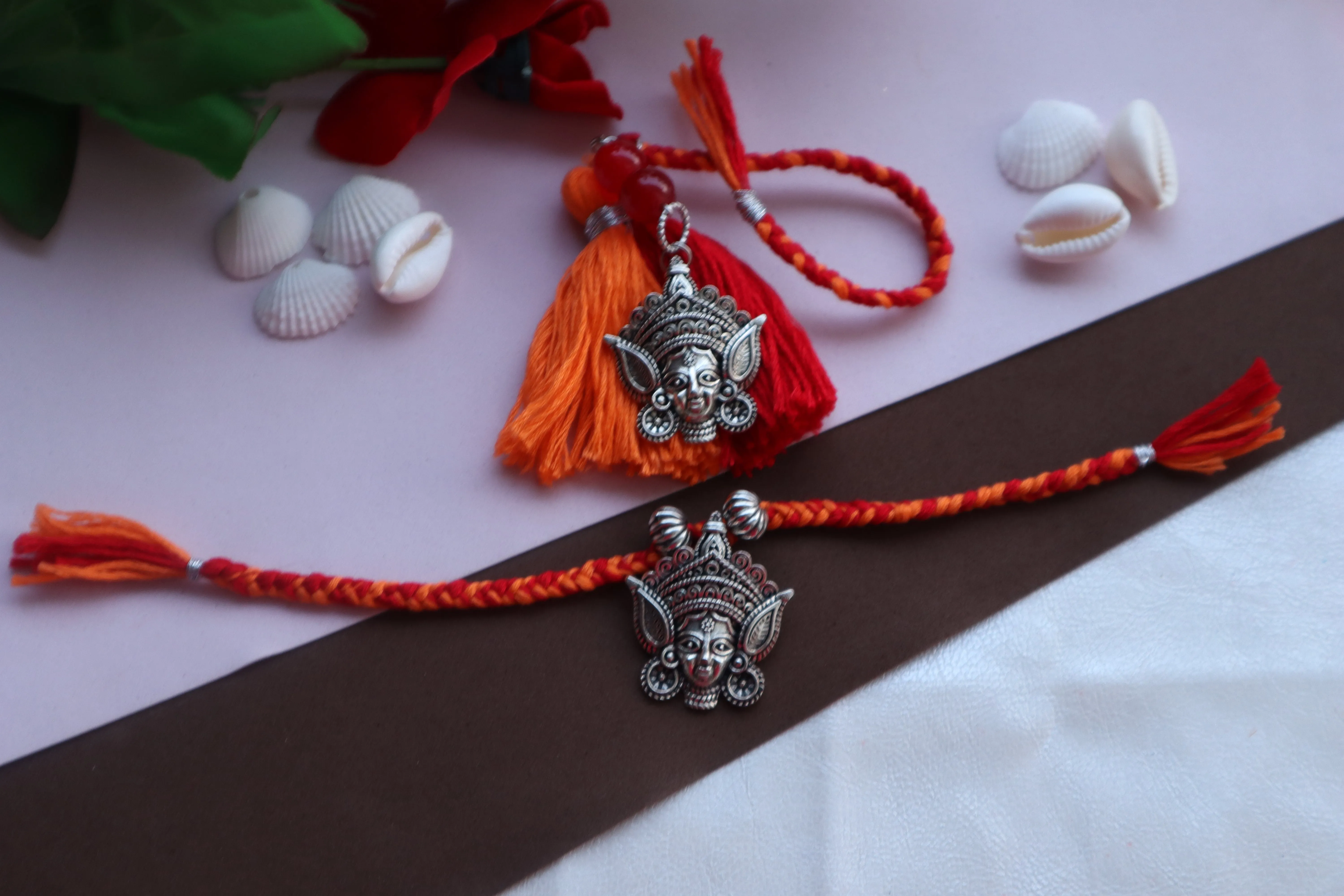 Kamule Durga Idol Rakhi  Bhaiya Bhabhi Rakhi Set of 2 - Red & Orange